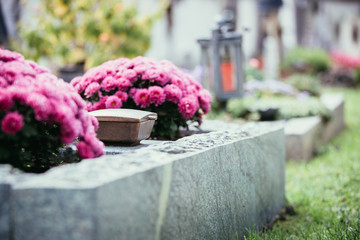 Holy water in iron bowl, cemetery, flowers - obrazy, fototapety, plakaty