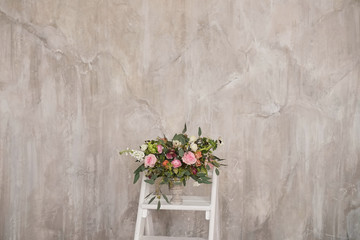 Autumn bridal bouquet of flowers stands on the white staircase stepladder