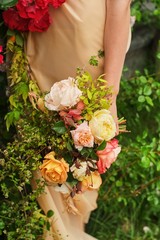 Wedding Photography: A bride in a silk wedding dress holding a beautiful big white, blush, pink, peach, orange wedding bouquet