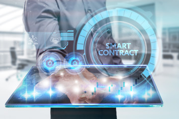 The concept of business, technology, the Internet and the network. A young entrepreneur working on a virtual screen of the future and sees the inscription: smart contract