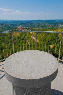 The view from the top of the Gonjace Observation Tower on Mejnik Hill, Primorska, Slovenia. Smartno is in the distance. In the foreground is a direction marker showing the names of various cities