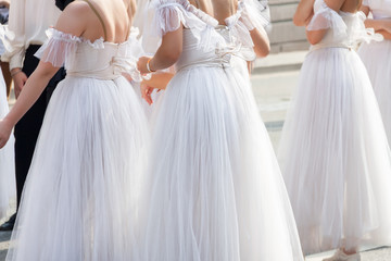 Group ballerinas in white dress await street classical modern ballet dance performance