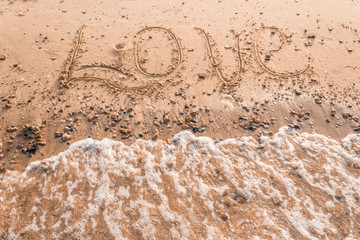 Summer drawn letters on a sandy beach. Text template pattern. Creative typography for holiday greetings.