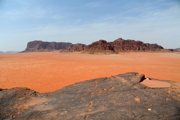 Red mountains of the canyon of Wadi Rum desert in Jordan. Wadi Rum also known as The Valley of the Moon is a valley cut into the sandstone and granite rock in southern Jordan to the east of Aqaba