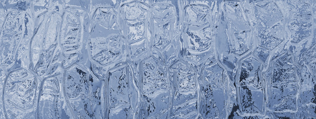 Abstract geometric texture of icy surface, transparent blue glass.