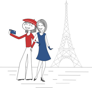 Two women take pictures of themselves with a mobile phone in Paris in front of the Eiffel Tower