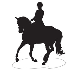A silhouette of a dressage rider on a horse executing the pirouette. © irinamaksimova