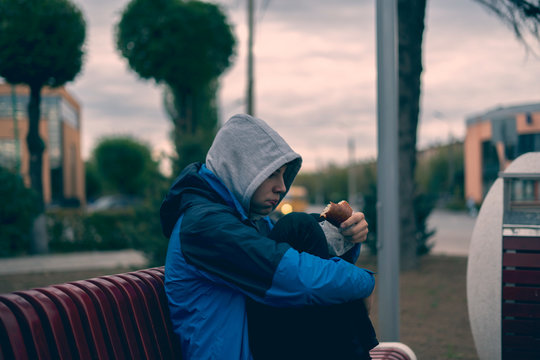 Teenage Homeless Poor Sad Child Eating Bread Food Outdoor In The Street  F