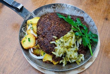 Original Bremer Knipp - crispy fried Haggis style oat grout’s dish of pork with fried potatoes,...