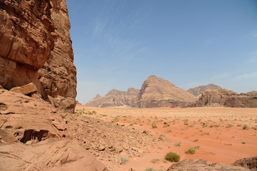 Fototapeta na wymiar Jordanian desert in Wadi Rum, Jordan. Wadi Rum has led to its designation as a UNESCO World Heritage Site. It is known as The Valley of the Moon