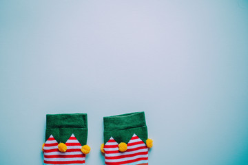 christmas background. minimalistic flat lay top view of elf socks. perfect for a festive merry xmas greeting card. enough room for copy space and text.