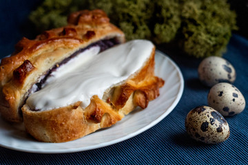 Homemade pie with cabbage, eggs and sour cream, close-up.