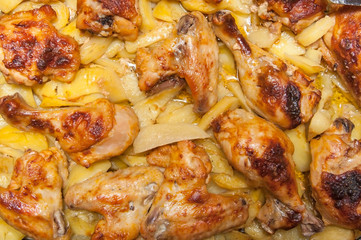 Fried chicken legs and wings and fried potatoes cooked at home
