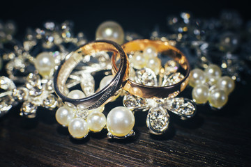 Wedding rings and shiny jewelry of the bride