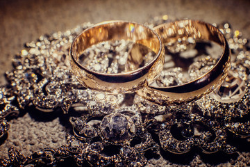 Wedding rings and shiny jewelry of the bride