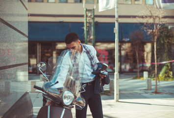 Urban businessman looking in the motorcycle