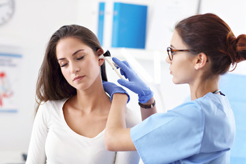 Adult woman having a visit at female laryngologist's office