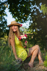 young woman with bunch of flowers outdoors