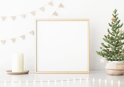 Square poster mock up with golden frame, decorated christmas tree, garland lights and holiday decoration on white wall background. 3D rendering.