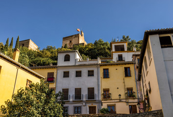 Fototapeta na wymiar Royal Alhambra Palace above a neighborhood in Granada, Spain