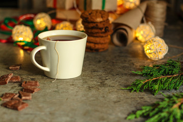 tea in a white cup (tea bag) gifts on the table. holiday atmosphere. top image. food background