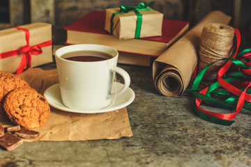 tea in a white cup (tea bag) gifts on the table. holiday atmosphere. top image. food background