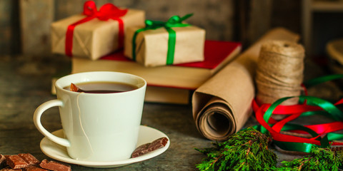 tea in a white cup (tea bag) gifts on the table. holiday atmosphere. top image. food background