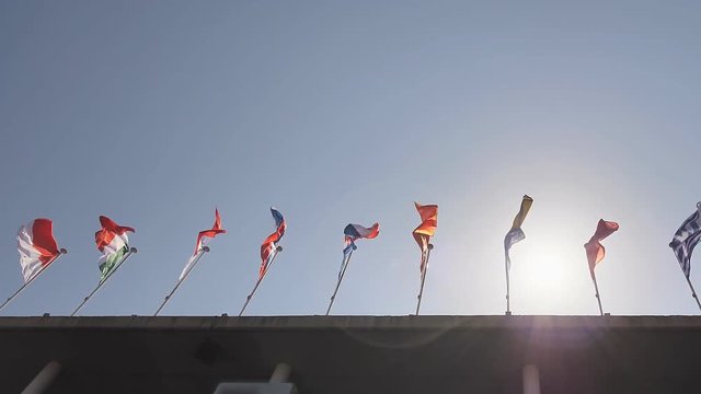Flags of the world hover over the building.