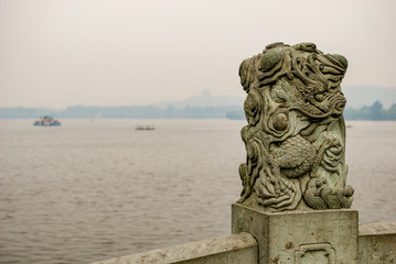 Fototapeta na wymiar Dragon sculpture on the top of stone railing around West Lake in Hangzhou China.