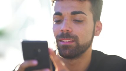 Millenial young man using his smartphone