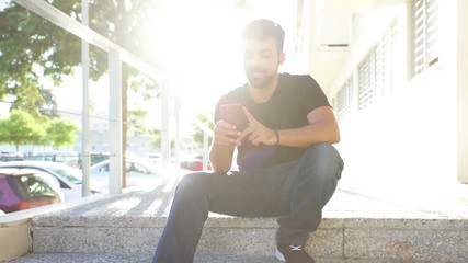 Millenial young man using his smartphone