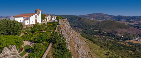 Igreja de Santa Maria medieval Church with typical white washed walls and garden in Marvao, Alto Alentejo, Portugal. View of Alto Alentejo landscape © StockPhotosArt