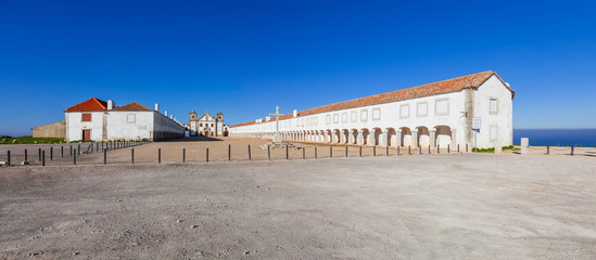 Santuario de Nossa Senhora do Cabo Sanctuary. Cabo Espichel Cape. Church, Pilgrim lodgings and stone cross. Baroque architecture. Sesimbra, Portugal © StockPhotosArt