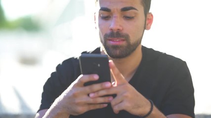 Millenial young man using his smartphone