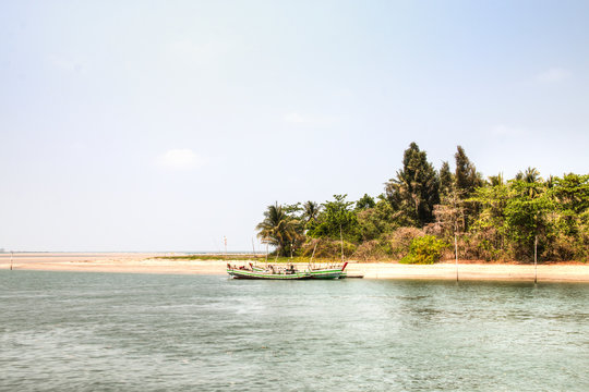 Coastal view with boat near the town Ngwe Saung in Myanmar

