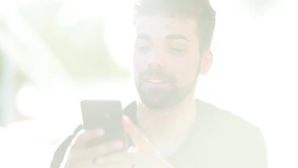 Millenial young man using his smartphone