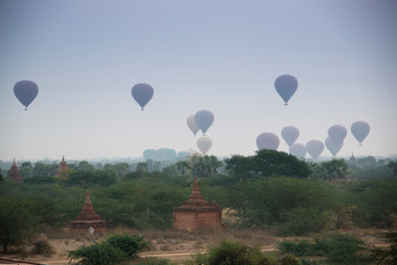 Fototapeta na wymiar Hot air balloons rise over the plains of Bagan, a historical site in Myanmar, in the early morning 