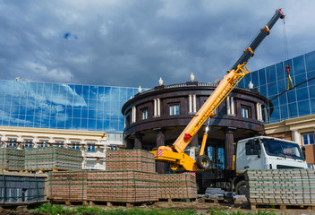 Truck-mounted crane on a building construction site