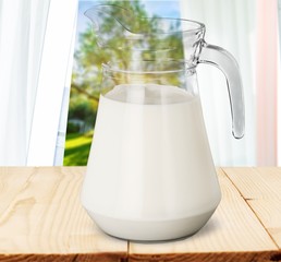Glass jug of fresh milk isolated on