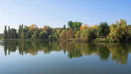 Autumn landscape with trees by the water.