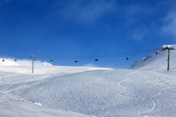 Gondola lift and off-piste ski slope in fog
