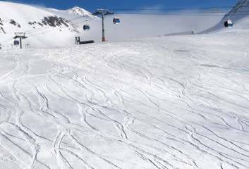 Snowy ski slope with trace from skis and snowboards