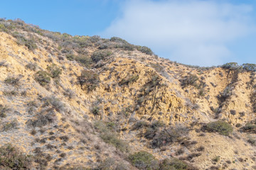 Dry, barren hillsides in foothills with erosion from years of wind and rain