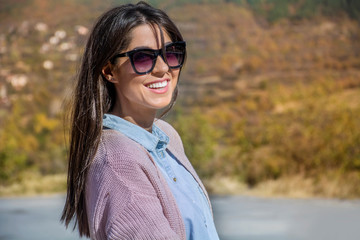 Beautiful Smiling Young  Woman with Sunglasses Outdoor in the Autumn