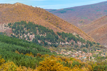 Beautiful Colorful Autumn Mountain with Small Village  in Bulgaria