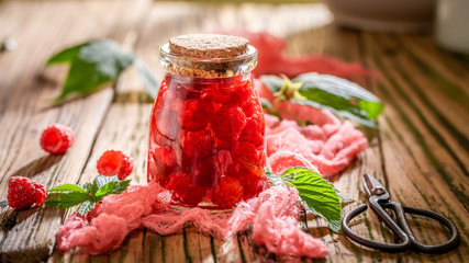 Homemade raspberry tincture made of fresh fruits and alcohol