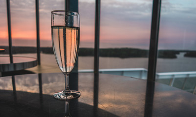 Enjoying a glass of champagne at the lounge bar at the evening on board a ship