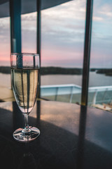Enjoying a glass of champagne at the lounge bar at the evening on board a ship