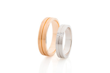 Pair of pink gold and white gold wedding rings with matte surface isolated on white background