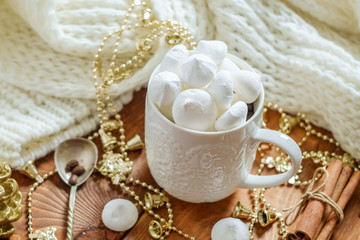 Christmas cup with  meringues on a Christmas decoration background